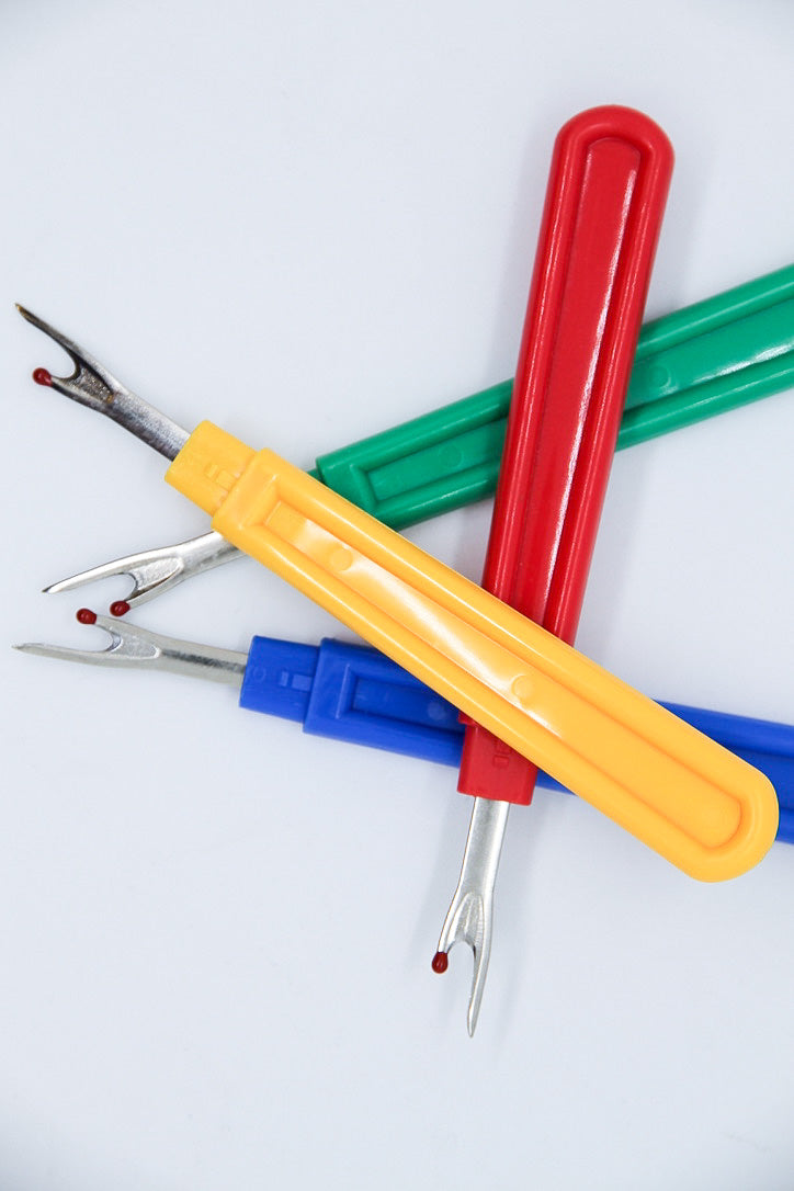 Full size Vision Saddlery seam ripper with a sharp metal blade and ergonomic handle for precise fabric seam removal.